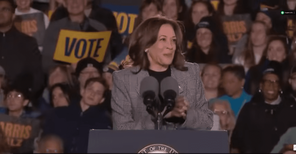 Vice President Kamala Harris speaking at a campaign rally podium in Ann Arbor, Michigan, on October 28, 2024.