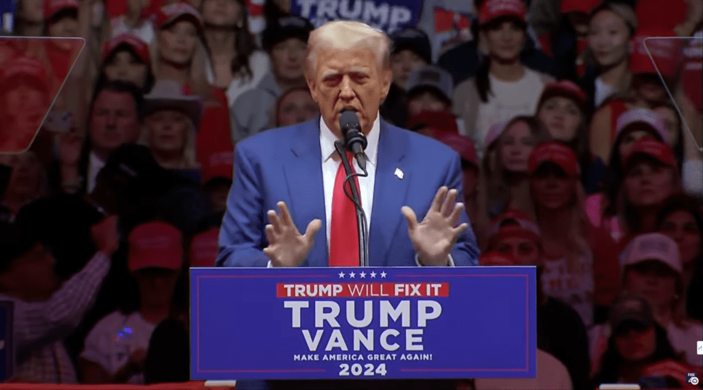 Former President Donald Trump speaks passionately at a rally at Madison Square Garden, addressing supporters on policies and promises.